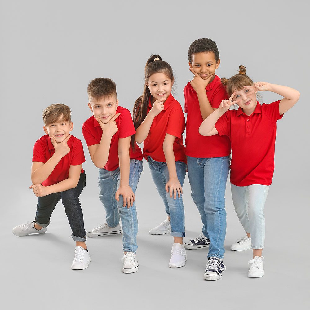 Five kids in red shirts ready to start dancing.